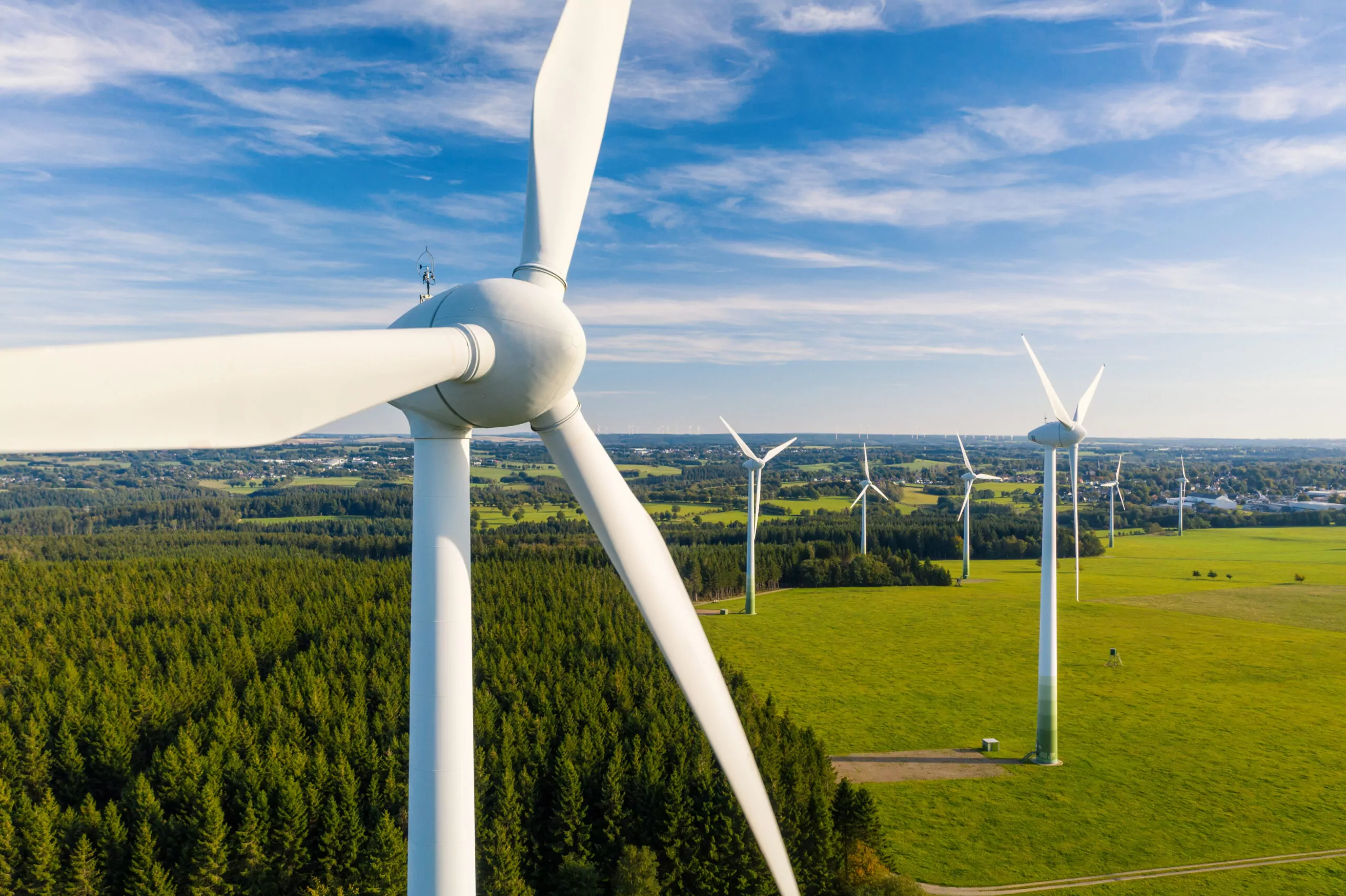 Aerial view of an onshore wind farm in a green rural landscape representing renewable energy grid connection in the UK